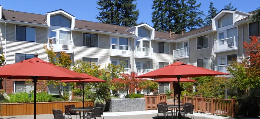 Outdoor seating area with umbrellas and beautiful landscaping
