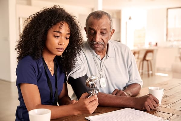 Staff member assisting a resident at a table