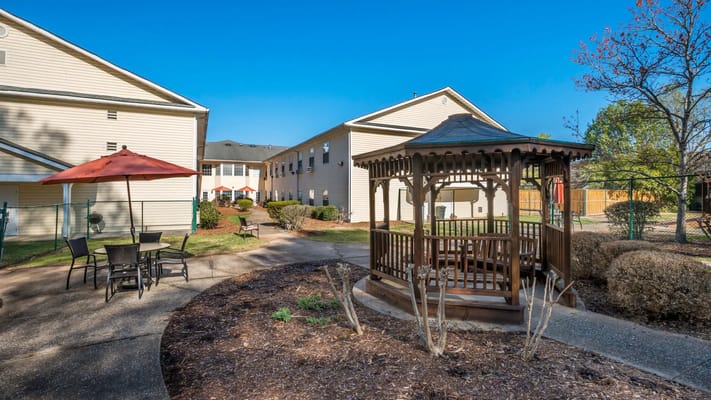 Outdoor seating area with a gazebo and garden path