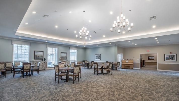 Brightly lit common area with tables and chairs