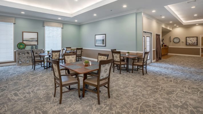 Light-filled common area with dining tables