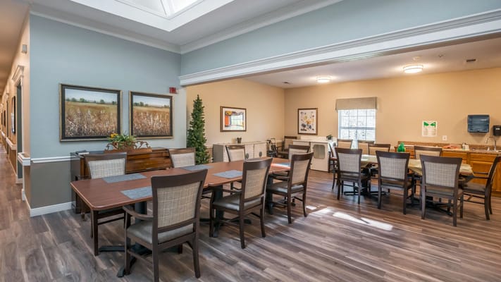 Bright common area with dining tables and artwork