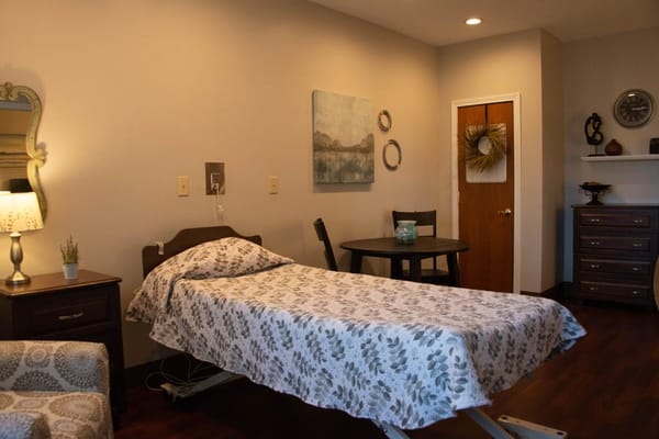 Cozy resident room with a bed and dining table