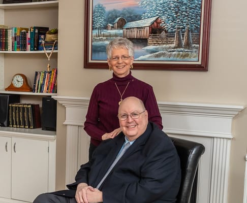 Two residents posing in a cozy facility setting