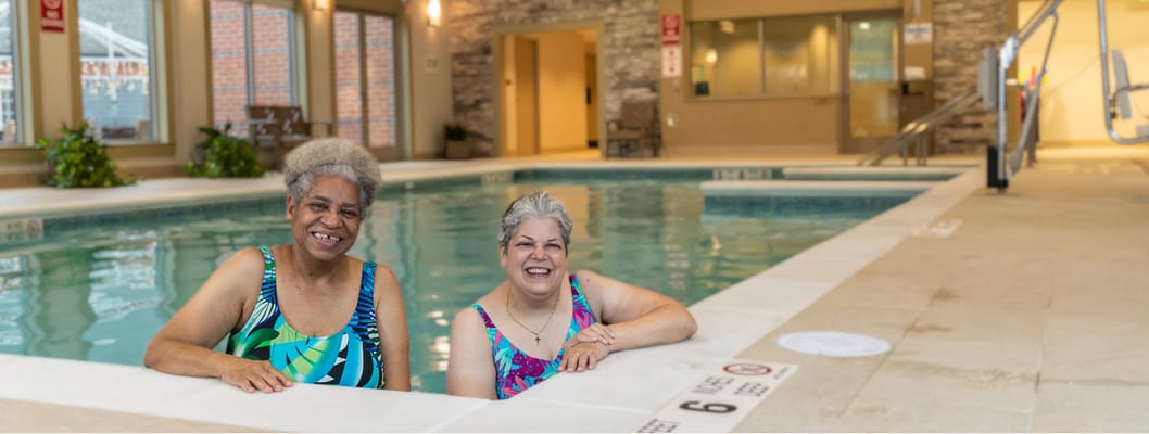 Two residents enjoying a swim in the indoor pool