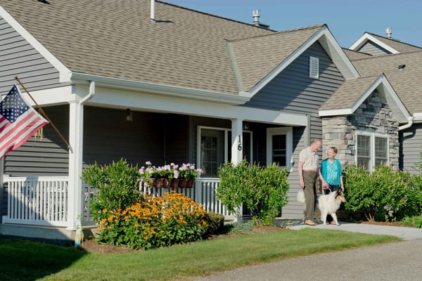 Residents enjoying the outdoors with a dog near their home