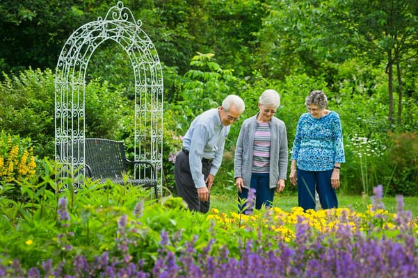 Residents enjoying a garden with flowers