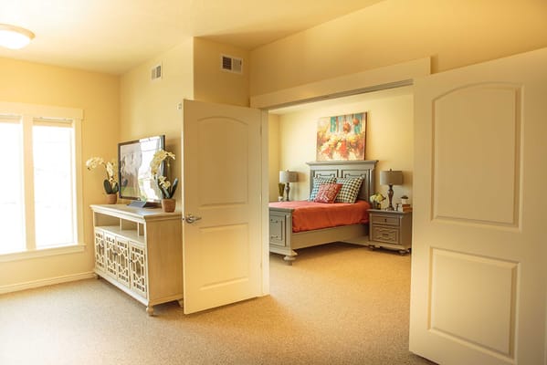 Brightly lit resident bedroom with warm colors