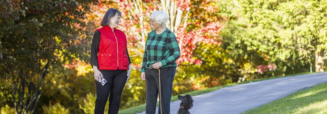 Two residents enjoying a walk in the garden