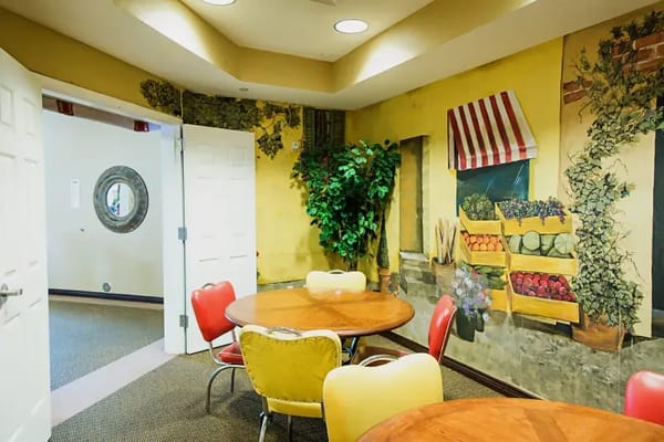 Colorful dining area with tables and mural