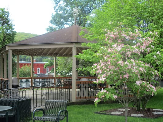 Charming gazebo surrounded by flowering trees