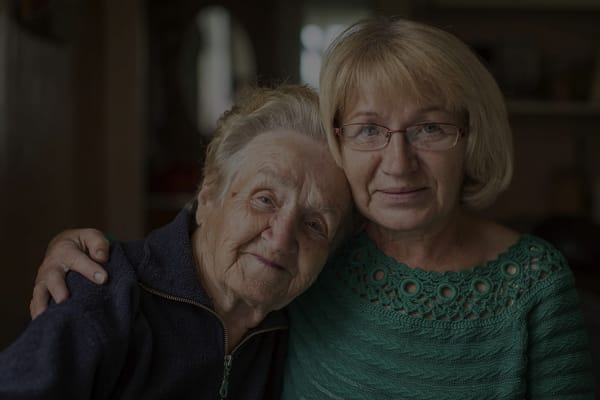 Two women sharing a warm moment in a cozy setting