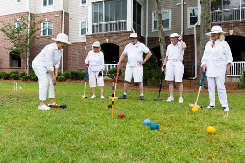 Residents enjoying a game of croquet outdoors