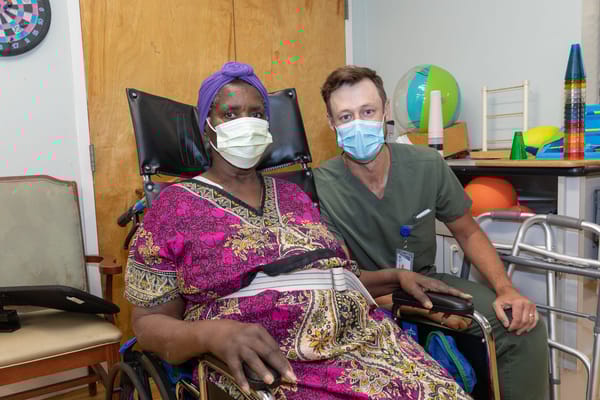 A resident and staff member in a therapeutic environment
