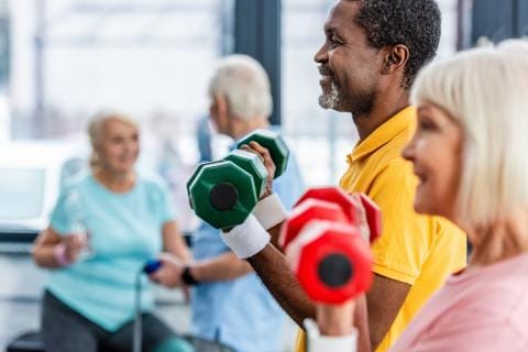 Residents participating in a weightlifting activity