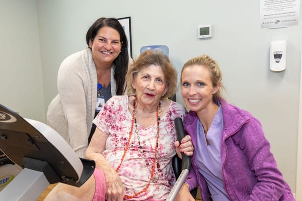 Staff with a resident in an activity room