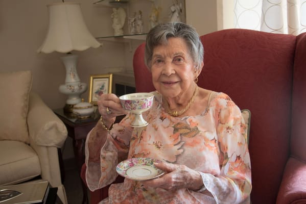 Resident enjoying tea in a cozy sitting area