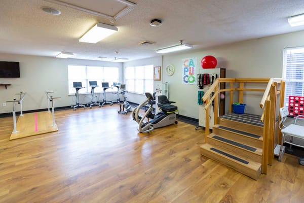 Interior view of a rehabilitation gym with exercise equipment
