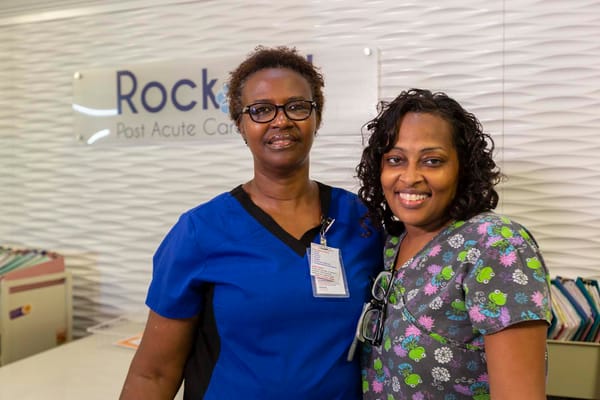 Staff members smiling together in the facility