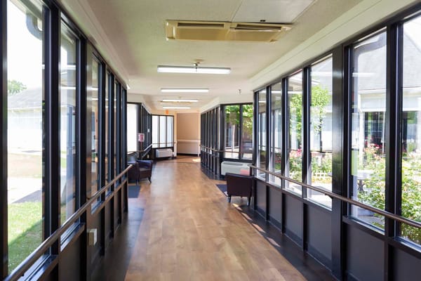 Bright hallway with large windows and seating area