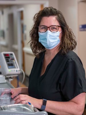 Staff member smiling while working in a facility