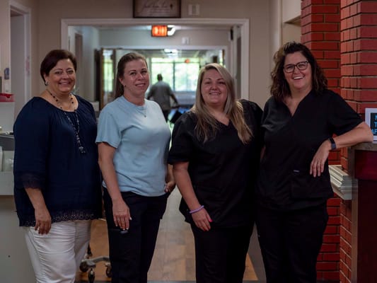 Staff members posing in the facility's hallway