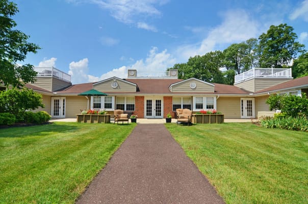 Front entrance of a senior living facility with landscaped gardens