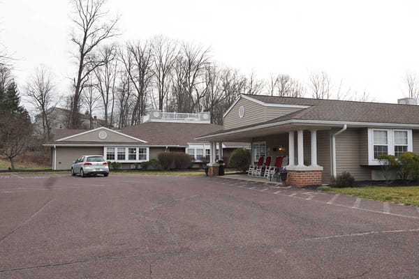 Exterior view of a senior living facility with parking