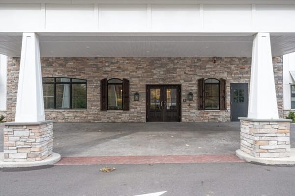 Entrance of a senior living facility with stone facade