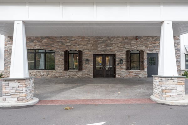 Entrance of a senior living facility with stone facade