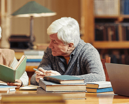 Residents engaged in reading in a cozy library