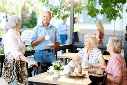 Residents enjoying drinks outdoors at a cafe