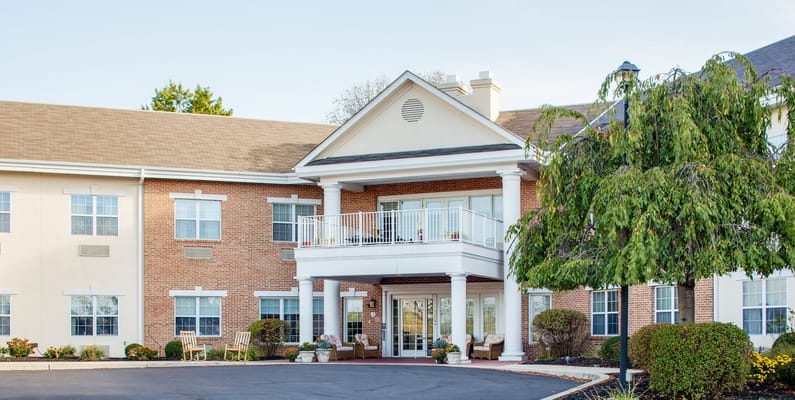 Exterior view of a senior living facility with landscaping