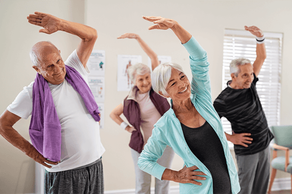 Seniors participating in a cheerful exercise class