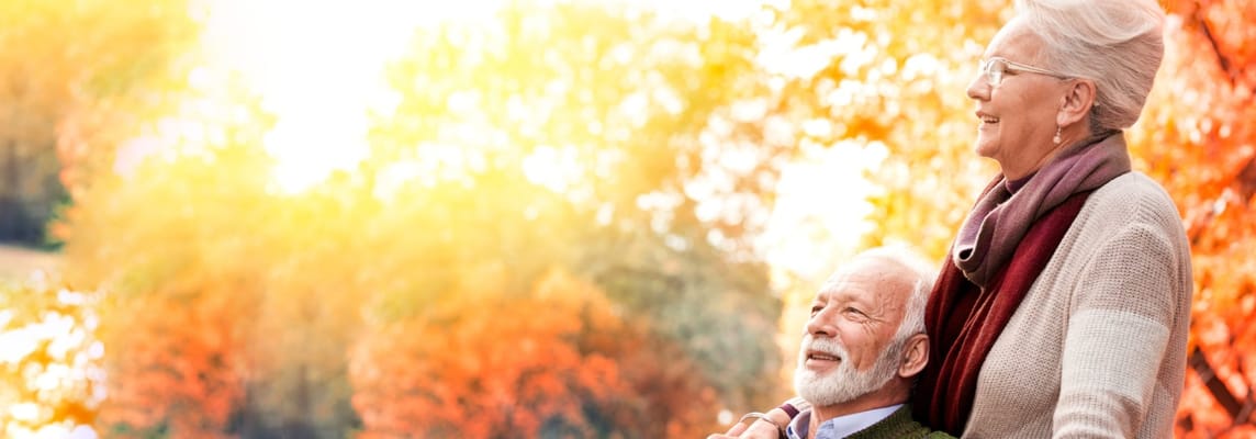 An elderly couple enjoying a sunny day in autumn