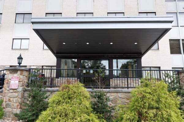 Front entrance of a senior living facility with landscaping