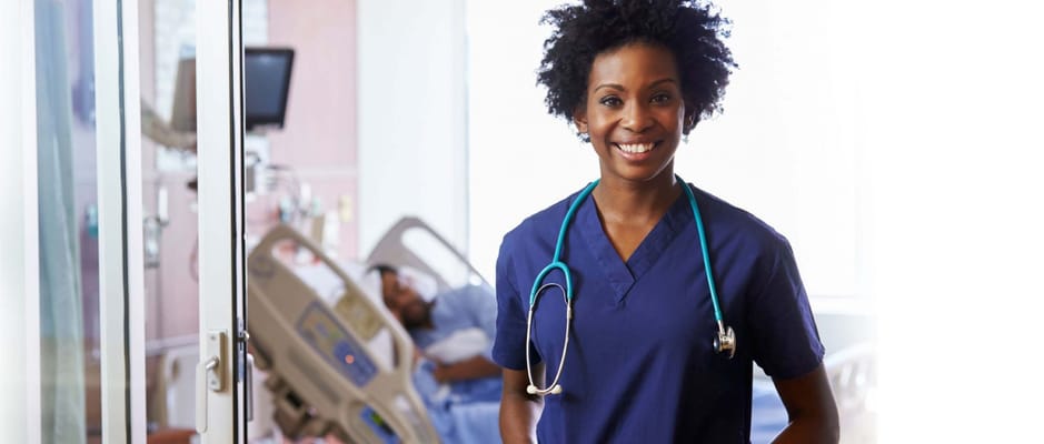 A nurse smiling in a facility interior