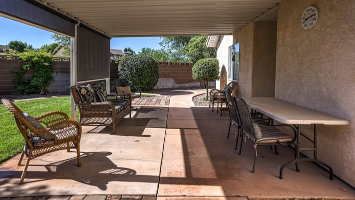Outdoor patio area with seating and greenery.