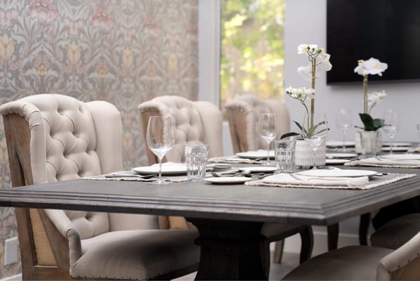 Elegant dining setup with stylish chairs and floral decor