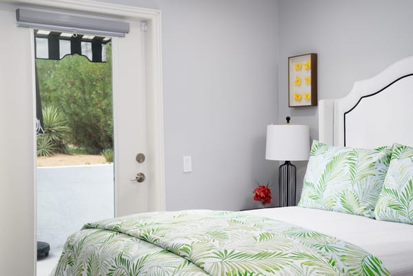 A cozy resident room with a bed and door to the outdoors