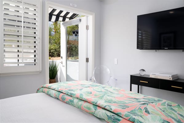 Brightly decorated resident room with open door to outdoor space