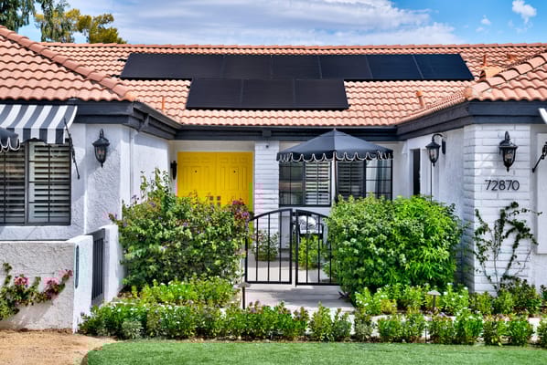 Exterior view of a nursing home with gardens and colorful entrance
