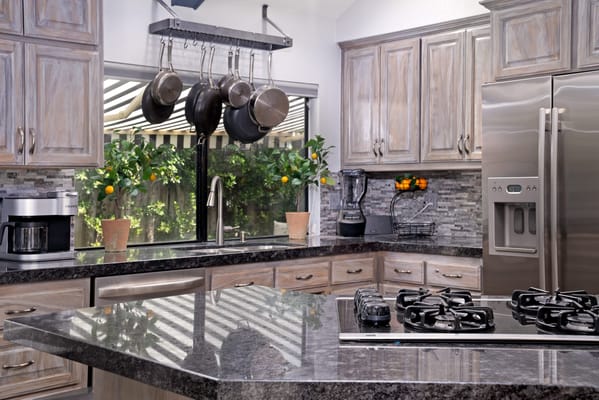 Modern kitchen with stainless steel appliances and plants