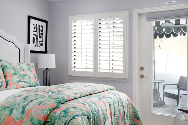 Cozy resident room with patterned bedding and outdoor view