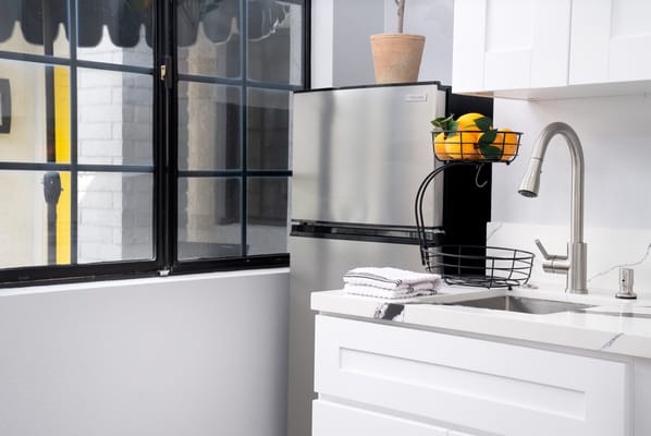 Modern kitchen area with plants and refrigerator