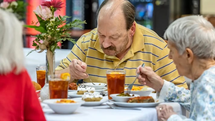 Residents enjoying a meal in the dining area