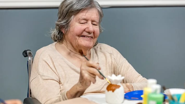 Resident painting during an activity session