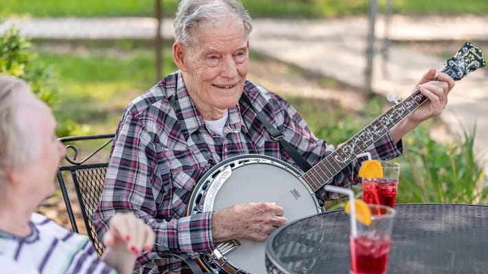 Residents enjoying music with drinks outdoors