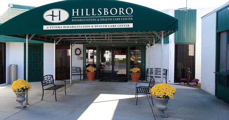Entrance of Hillsboro Rehabilitation & Health Care Center with flowers