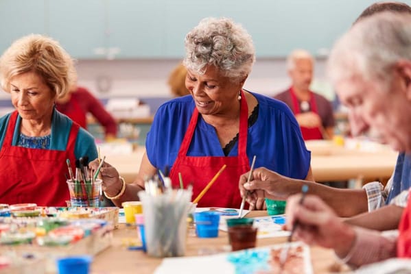 Residents engaged in a painting activity during art class